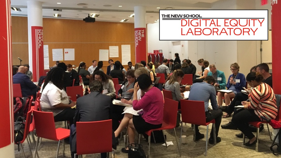 A full room of people at tables under a Digital Equity Laboratory banner