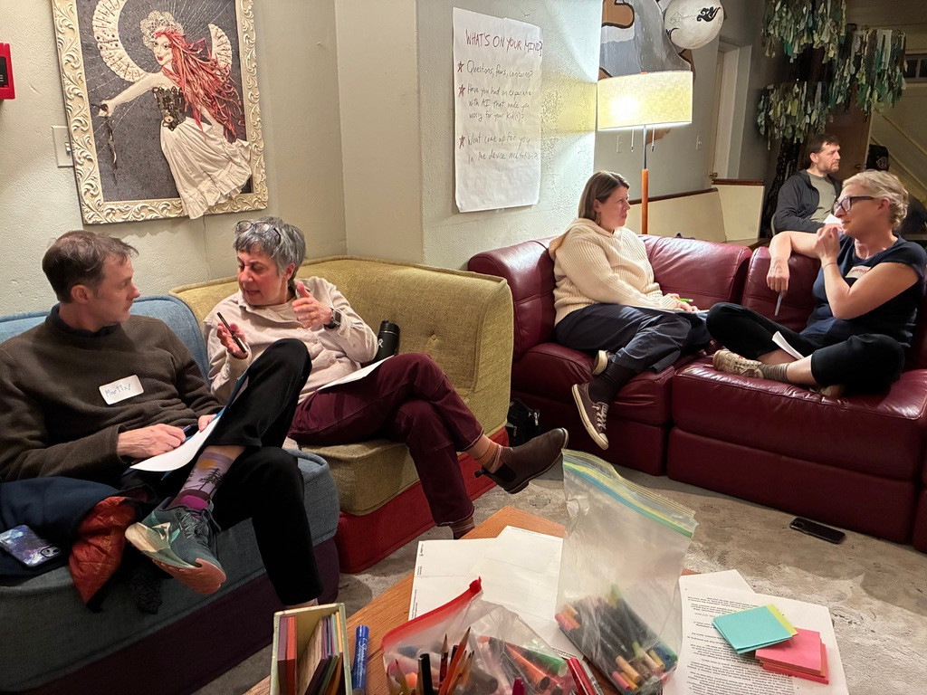 People sitting on couches in pairs discuss kids and AI at a December 2025 workshop in Beacon, NY